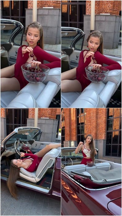 Russian teen Maria Talanova in sexy tight red dress, posing in car.